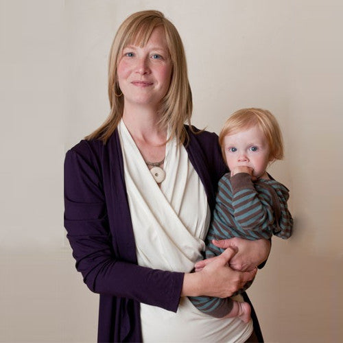 Maggie wears the Ivory Sleeveless Crossover Shirt with the Jet Set Jacket in Crocus for an elegant and breastfeeding-friendly outfit.